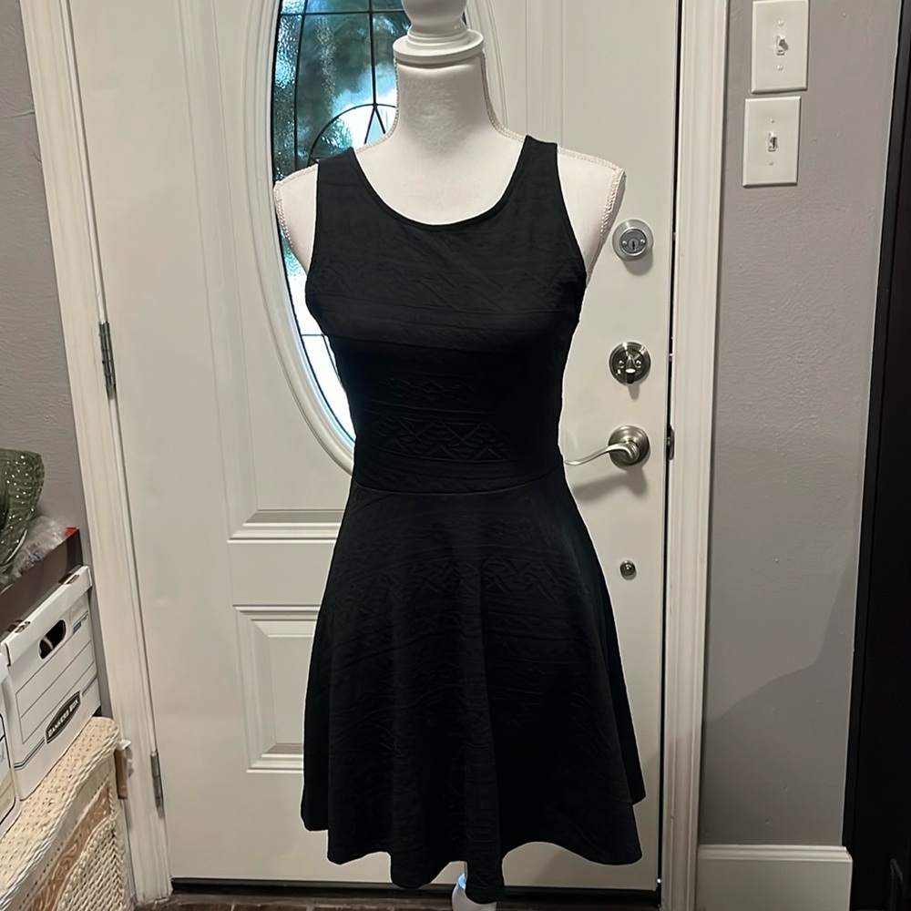 Ginger G Black Sleeveless Dress. Size M. Has crisscrossed back and flared bottom